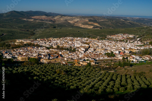 Dona Mencia town surrounded by olive trees landscape at sunrise, Sierra Subbetica, Cordoba, Andalusia, Spain. View from peak Oreja de la Mula, hiking destination. High quality photo photo