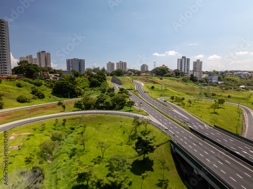 aerial view of a highway in Sao Jose dos Campos, mid size city in Sao Paulo state, Brazil with the city skyline in the background