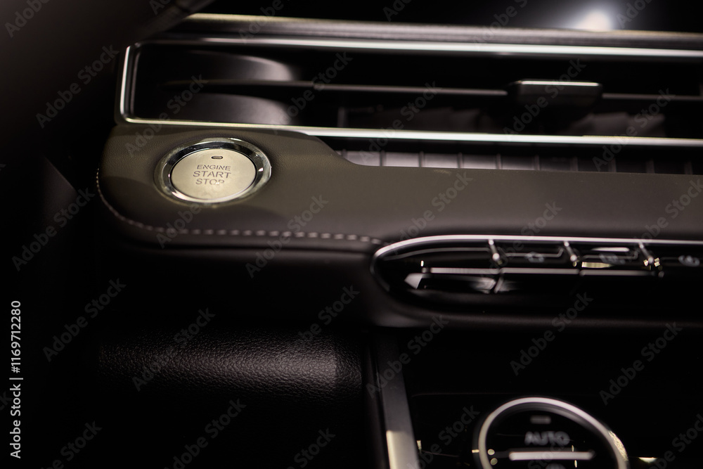 The image displays a detailed view of a cars start stop button The image displays a detailed view of a cars start stop button