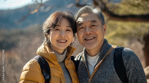 A charming portrait of a mature Korean couple, showcasing their handsomeness and beauty during an outdoor travel adventure. photo