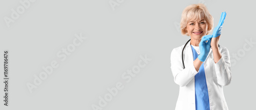 Female doctor putting glove...