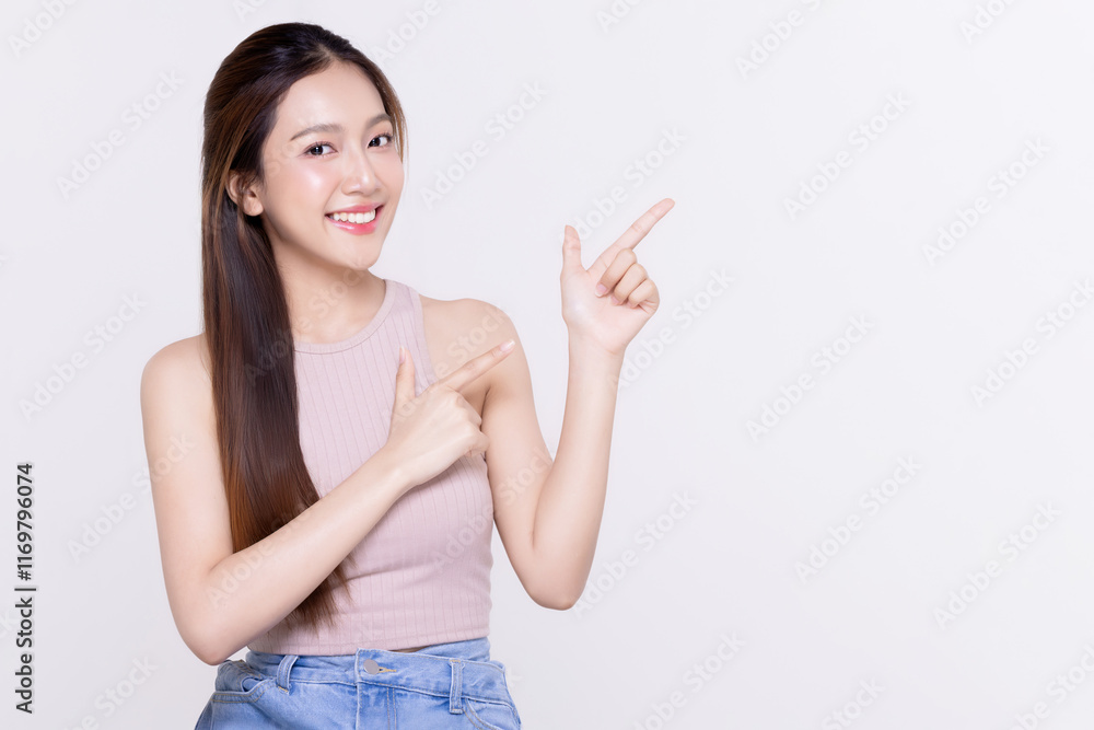 Beautiful long smooth hair Asian woman with happy clean skin face pointing finger to copyspace isolated on white background. Beautiful long smooth hair Asian woman with happy clean skin face pointing finger to copyspace isolated on white background.