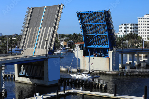 Aerial view of the Las Olas Bridge opening as a sailboat travels on the intracoastal waterways in Fort Lauderdale, Florida, USA. 