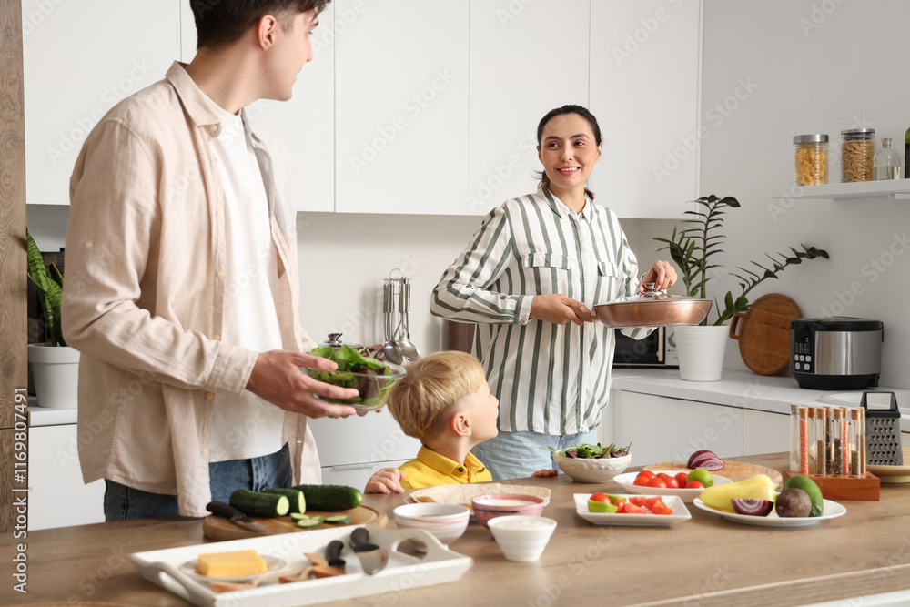 Fototapeta premium Happy little boy with his parents cooking Fajita in kitchen