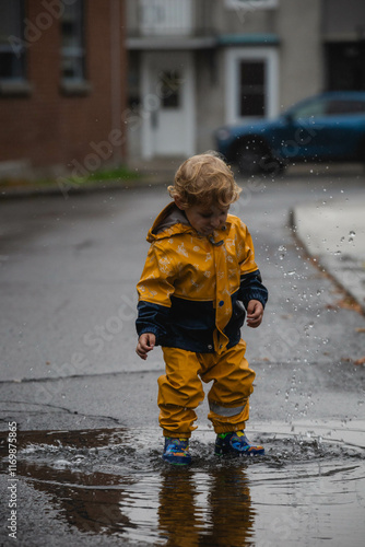 little boy playing in a puddle  photo