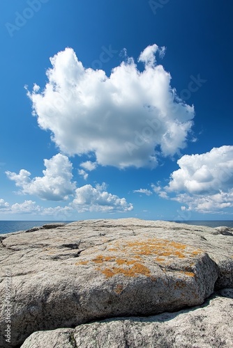 Sunny coastal rockscape with fluffy clouds. photo