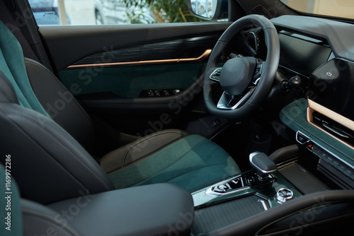 Closeup of a modern car steering wheel with control buttons for technology and convenience
