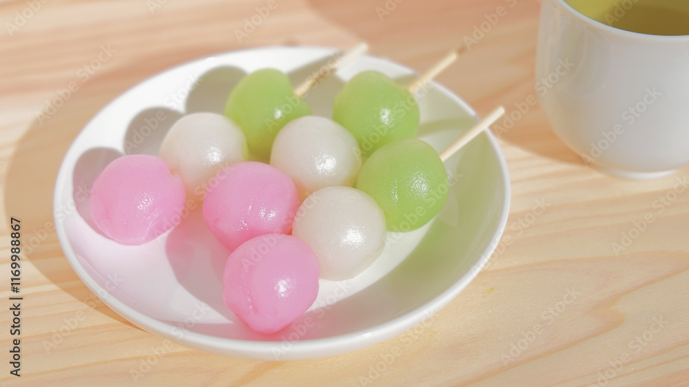 Spring image of three-colored Japanese mochi sweets with green tea Spring image of three-colored Japanese mochi sweets with green tea