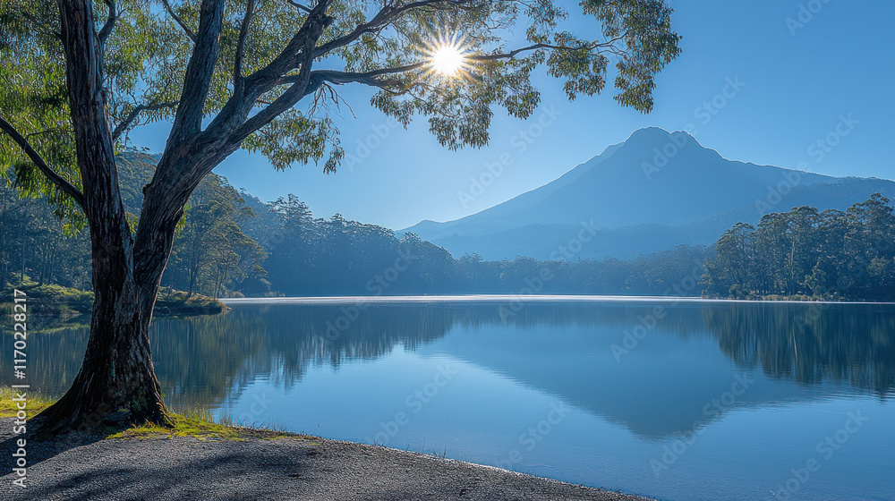 Serene morning lake reflecting mountain, sun peeking through tree. Serene morning lake reflecting mountain, sun peeking through tree.