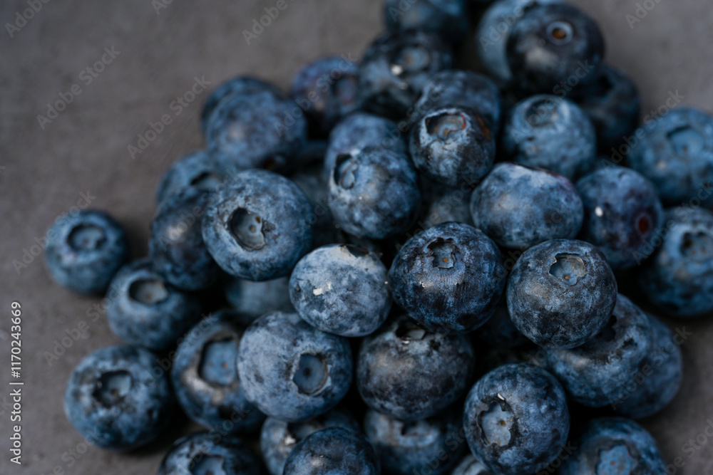 Close-up of blueberries on dark background.Fresh Blueberry Bounty. Close-up of ripe juicy blueberries filling the frame
