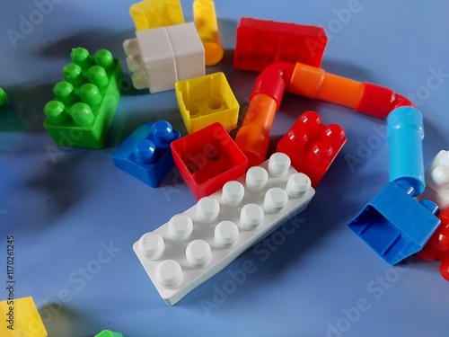 plastic toy blocks.  Colorful building blocks scattered on a blue surface