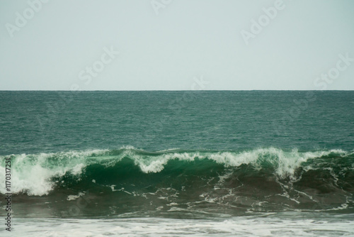 waves breaking on the beach. Ocean waves breaking on a  beach. Close up shot of breaking wave Pandansari beach, Central Java, Indonesia. photo