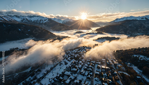 Lever de soleil sur un village enneigé en montagne photo