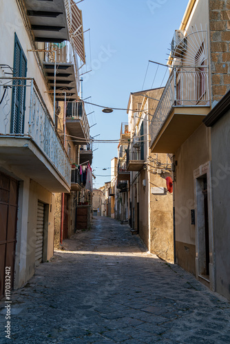 Pietraperzia, Sicily, Italy. Historical city center. Narrow street with houses. Summer sunny day photo