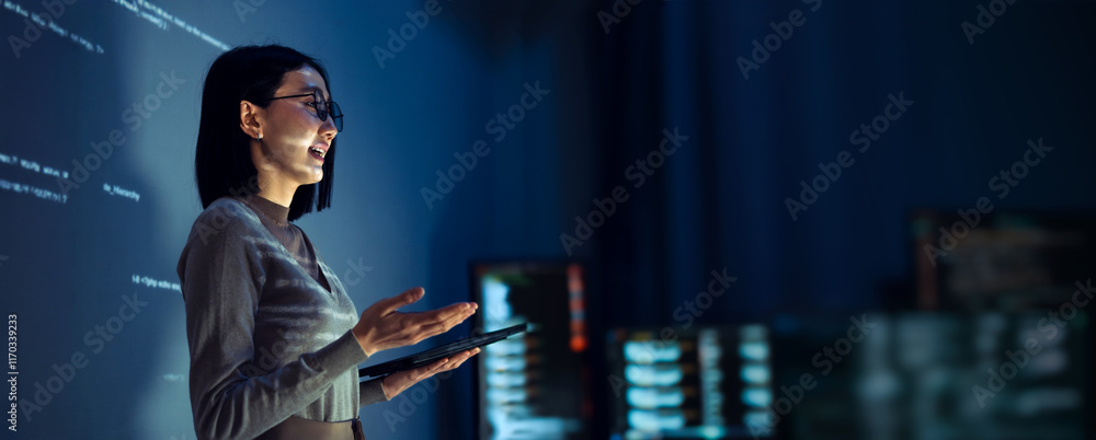 © weedezign - asian woman programmer standing in front of a screen with code projected presentation the integration of technology and human expertise in software development © weedezign - asian woman programmer standing in front of a screen with code projected presentation the integration of technology and human expertise in software development