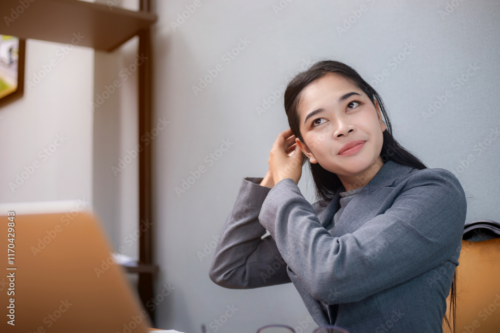 Businesswoman using digital tablet and laptop or working remotely at office, looking at digital tablet, watching webinar, learning training and looking at paper report. Businesswoman using digital tablet and laptop or working remotely at office, looking at digital tablet, watching webinar, learning training and looking at paper report.