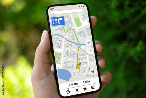 man hand hold phone with navigation application screen on street