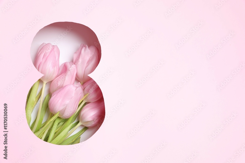 Fototapeta premium Paper cut out figure eight on pink background with fresh tulips. Concept of 8 march, Women's day