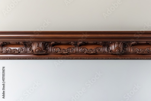 Ornate wooden crown molding detail on a wall.
