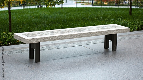 An isolated view of a modern stone bench with durable metal legs, seamlessly integrated into a peaceful park landscape. The clarity of the photograph captures the texture of the stone as well as the photo