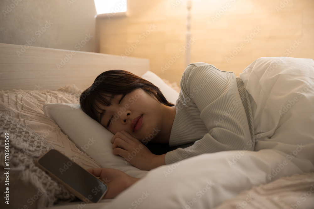 Woman who fell asleep while looking at her phone Yellow indirect lighting Woman who fell asleep while looking at her phone Yellow indirect lighting