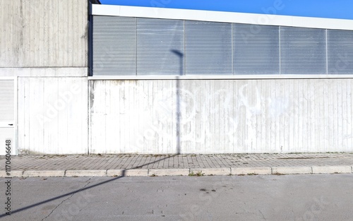 Wallpaper Mural Industrial building made of concrete and metal at the roadside. Cement tiled sidewalk and street in front. Background for copy space. Torontodigital.ca