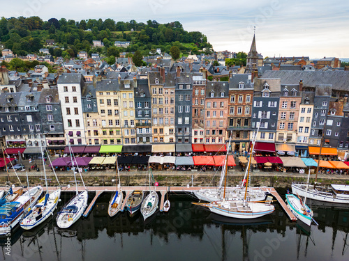 Obraz na płótnie A charming harbor lined with yachts and sailboats surrounded by historic, colorful buildings in a picturesque port town Honfleur, France w salonie
