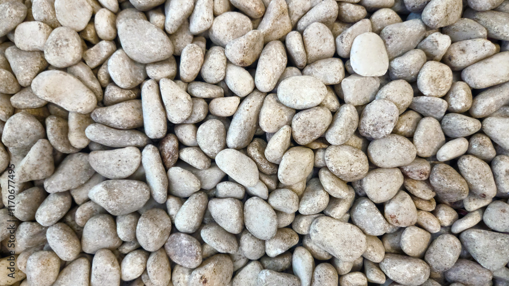Stone wall texture with natural grey rocks and smooth pebbles forming an abstract outdoor pattern Stone wall texture with natural grey rocks and smooth pebbles forming an abstract outdoor pattern