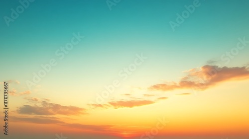 Serene sunset sky with orange and teal hues.