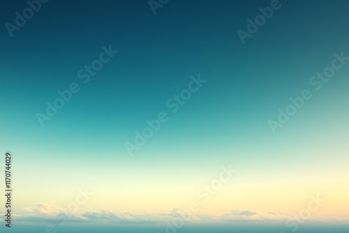 Tranquil teal and yellow gradient sky at dawn or dusk.
