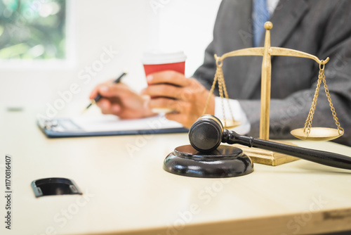 Male lawyer diligently examines documents placed on his desk, demonstrating his professionalism and dedication to finding legal truth, analyzing ideas, and pursuing justice with relentless focus. photo