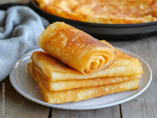 Crepes (Russian Blini) on wooden background, top view. Homemade thin fresh crepes for breakfast photo