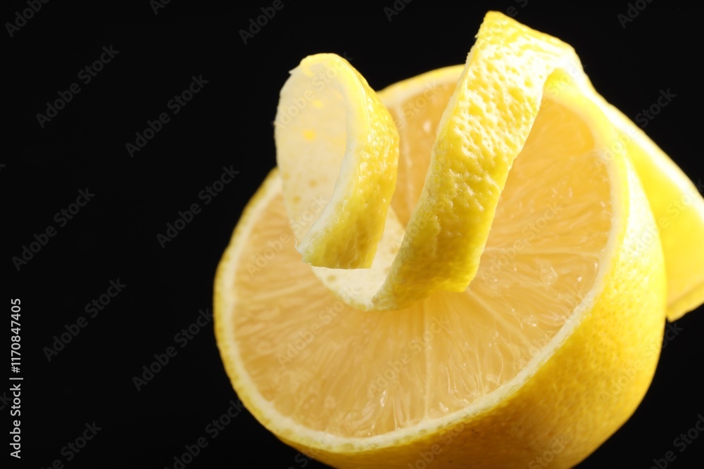 Fresh lemon peel and half of fruit on black background, closeup. Space for text Fresh lemon peel and half of fruit on black background, closeup. Space for text