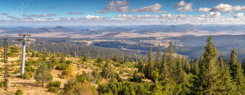 Scenic view of mountain valley in Serbia with ski lift and evergreen forest in autumn photo