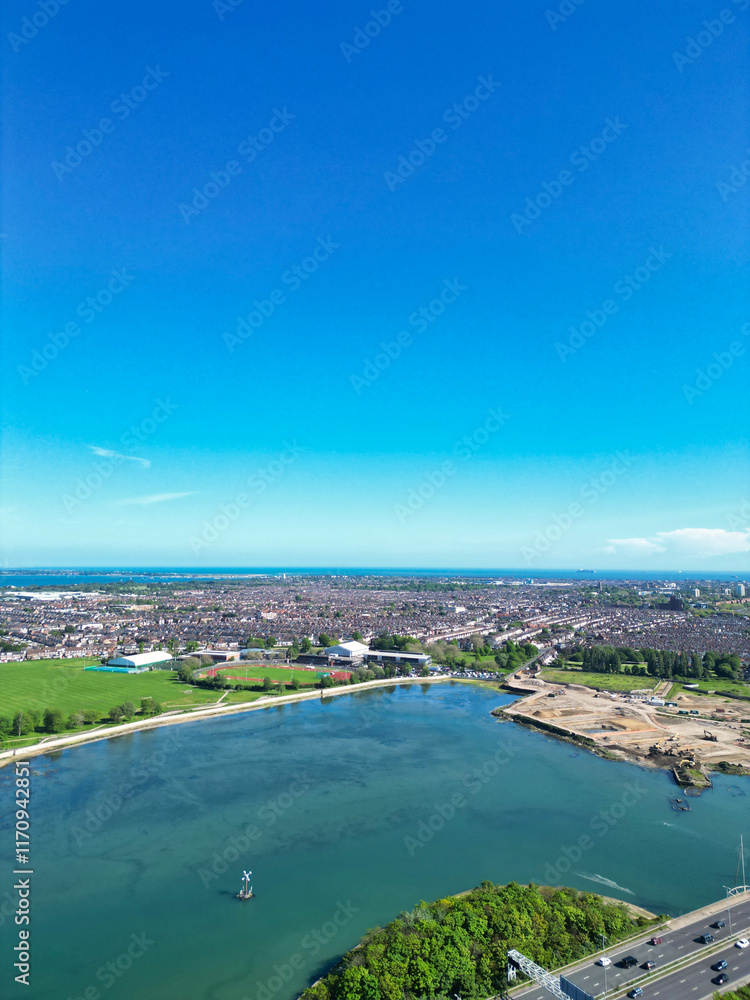 Fototapeta premium Portsmouth City Located at Beach and Sea Front Port Docks of England’s south coast, United Kingdom. Aerial Footage Was Captured with Drone's Camera on May 15th, 2024.
