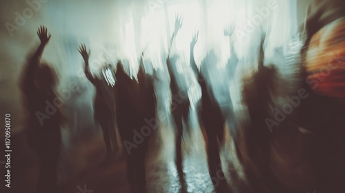 Blurred silhouettes of people dancing in a smoky club.