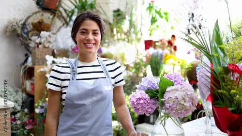 Video portrait of a beautiful, young florist working at her store