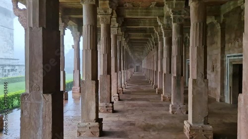 Walking Through the Pillared Corridor of Jami Masjid in Misty Mandu, India. photo