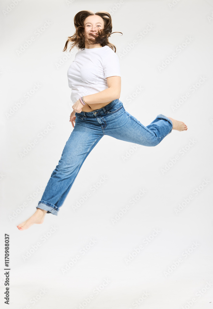 Studio portrait of teenager jumping. Studio portrait of teenager jumping.