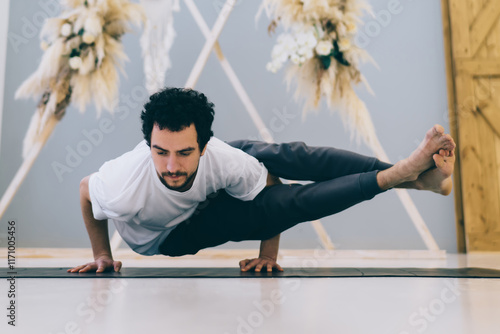 Focused man doing Eight Angle position photo