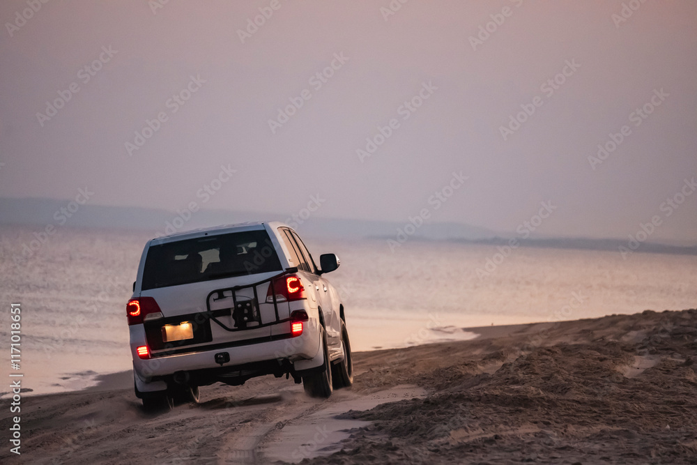 A safari tour with off-road vehicles in Doha, Qatar, where the desert sands and sea sands meet A safari tour with off-road vehicles in Doha, Qatar, where the desert sands and sea sands meet
