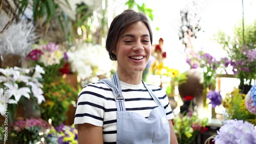 Portrait of a happy florist enjoying amongst flowers