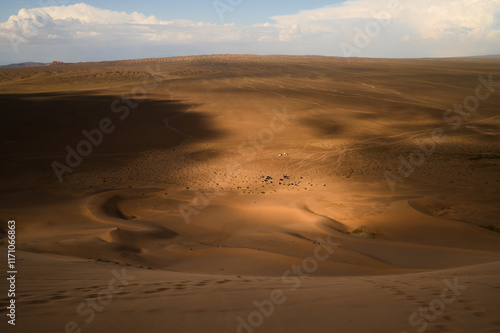 A stunning view of the Khongor Sand Dunes in the Gobi Desert, Mongolia, with dramatic light and shadows.