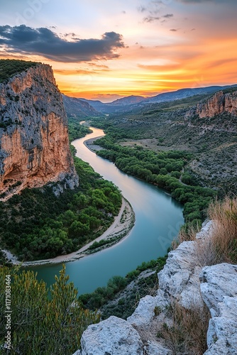 Stunning sunset illuminates winding river, surrounded by dramati photo