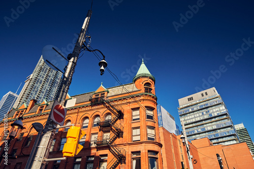 Canvas Print Low angle view of  The Gooderham Building, also known as Flatiron, in a sunny and cloudy day