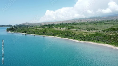 Aerial flyover of lake Issyk-Kul in Kyrgyzstan. Issyk-Kul is the second largest navigable alpine lake in the world photo