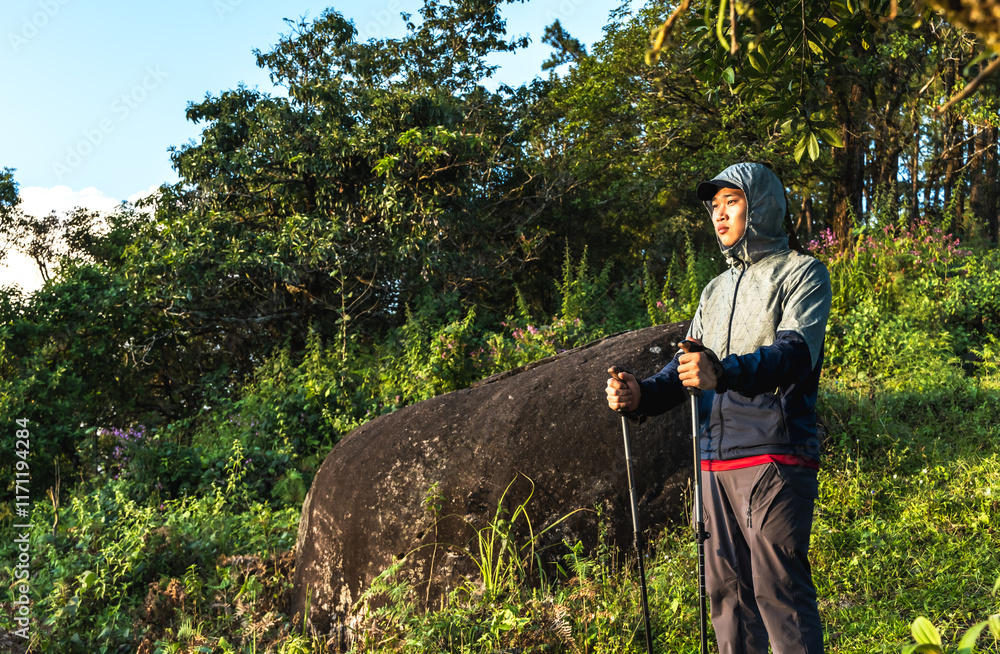 Asian hiker man with hiking poles in nature park Asian hiker man with hiking poles in nature park