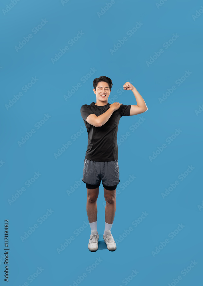 ImageFull body image of Asian guy wearing workout clothes and posing on a blue background ImageFull body image of Asian guy wearing workout clothes and posing on a blue background