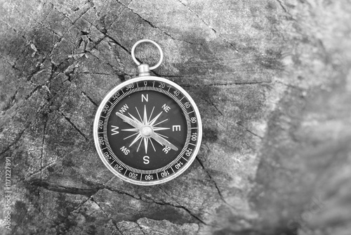 Classic navigation compass on natural background photo