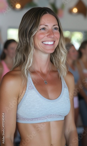Smiling woman in fitness class, blurred background of other participants Free Download Smiling woman in fitness class, blurred background of other participants - GFXLoad